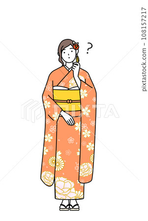 A woman in a long-sleeved kimono tilts her head in question, at a New Year's shrine visit, a coming-of-age ceremony, a graduation ceremony, a wedding, etc. 108157217