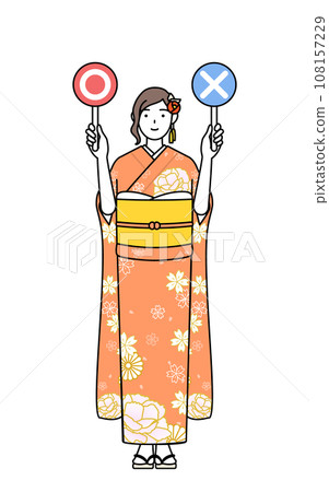 身穿長袖和服的女性手持棍子來表示正確和錯誤的答案,常用於新年參拜、成年儀式、畢業典禮、婚禮等場合。 身穿長袖和服的女性手持棍子來表示正確和錯誤的答案,常用於新年參拜、成年儀式、畢業典禮、婚禮等場合。 108157229