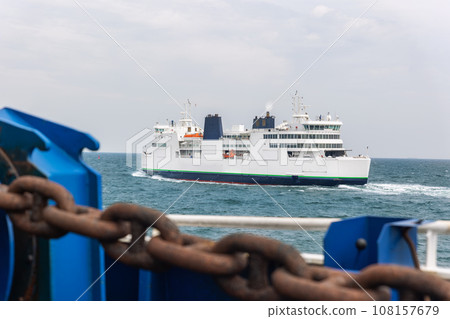 Big modern shuttle passenger freight cargo ferry boat vessel ship with loaded cars and vehicles floating Baltic or North sea . Sea transportation ferryboat transport carrier. Northern Europe sea line 108157679