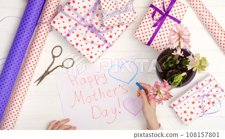 Small girl drawing a greeting card 108157801