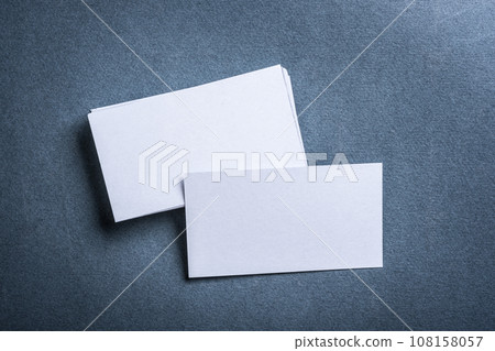 Blank white business card on grey background top view. Blank white business card on grey background top view. 108158057