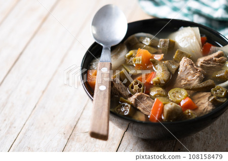 Traditional African okra soup on wooden table 108158479