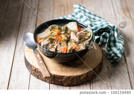 Traditional African okra soup on wooden table 108158480