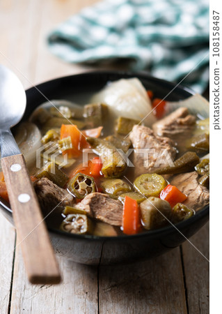 Traditional African okra soup on wooden table 108158487