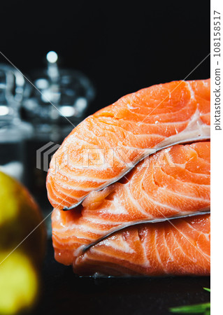 Fresh raw salmon fillet with seasonings and herbs 108158517
