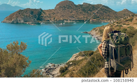 Girl is traveling in Turkey. View of lighthouse in ancient city of Knidos Girl is traveling in Turkey. View of lighthouse in ancient city of Knidos 108158940