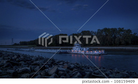 towboat with barges on Chain of Rock Bypass Canal of Mississippi River above St Louis, night scenery at dawn 108159409