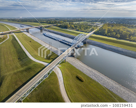 towboats with barges on Chain of Rock Canal of Mississippi River above St Louis, aerial view in October scenery 108159431