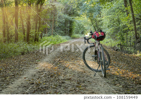 gravel touring bike on Katy Trail near McKittrick, Missouri, in fall sunset scenery gravel touring bike on Katy Trail near McKittrick, Missouri, in fall sunset scenery 108159449