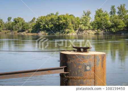 rusty mooring pile with a cleat for barges on the Missouri River at Brownville, Nebraska rusty mooring pile with a cleat for barges on the Missouri River at Brownville, Nebraska 108159450