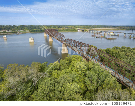 Chain of Rocks on the Mississippi RIver above St Louis with water towers, old historic bridge and the new bridge with construction work Chain of Rocks on the Mississippi RIver above St Louis with water towers, old historic bridge and the new bridge with construction work 108159471
