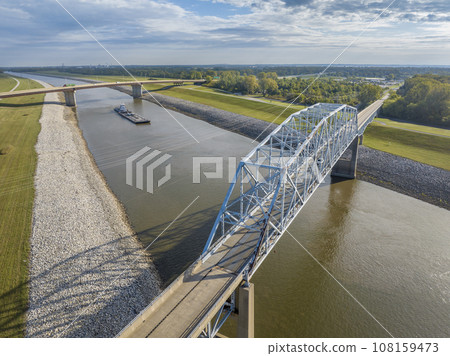 towboats with barges on Chain of Rock Canal of Mississipi River above St Louis, aerial view in October scenery 108159473