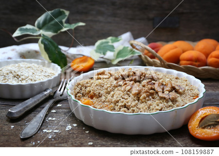 Apricot crumble from oatmeal, walnuts dressing 108159887