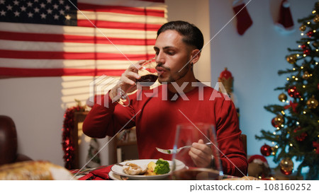 Man enjoying Thanksgiving dinner with USA flag in the background Man enjoying Thanksgiving dinner with USA flag in the background 108160252