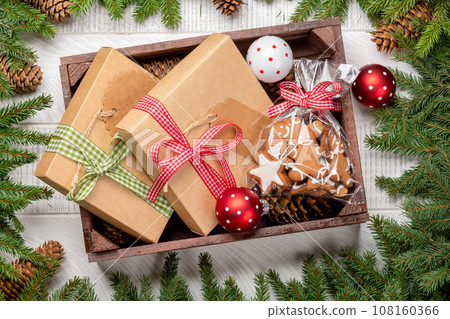 Box with Christmas gingerbread cookies and gift boxes Box with Christmas gingerbread cookies and gift boxes 108160366