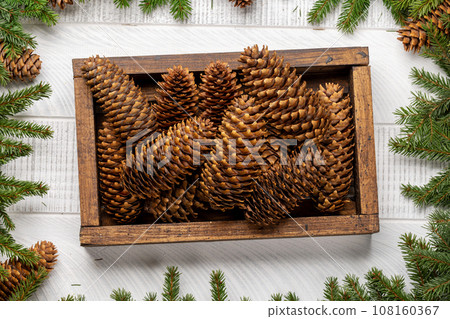 Box with Christmas fir tree cones Box with Christmas fir tree cones 108160367