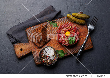 Savory beef tartare and brown bread toasts Savory beef tartare and brown bread toasts 108160448