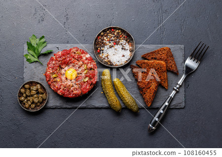 Savory beef tartare and brown bread toasts 108160455