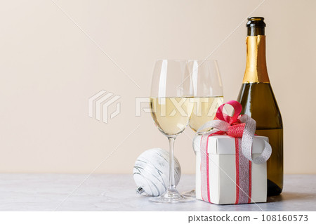 Two champagne glasses and gift box 108160573