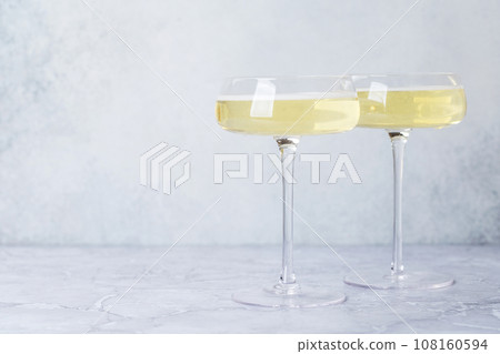 Two champagne glasses on a stone 108160594