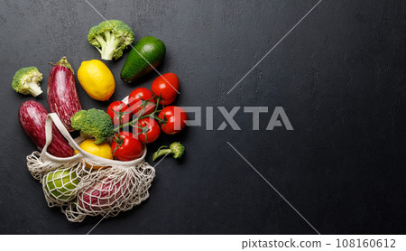 Mesh bag filled with a variety of vegetables Mesh bag filled with a variety of vegetables 108160612