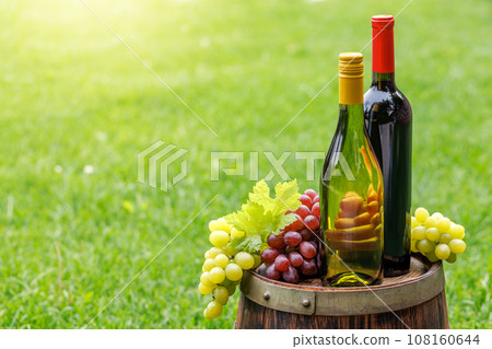 Wine bottles and grape on barrel Wine bottles and grape on barrel 108160644