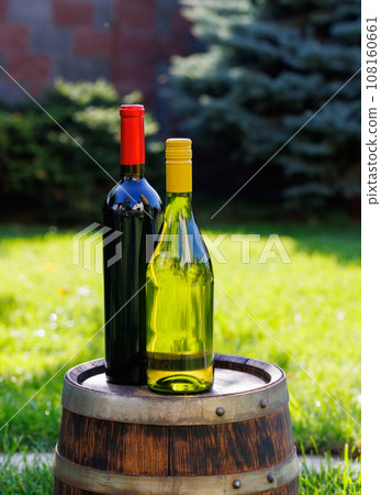 Wine bottles on barrel 108160661