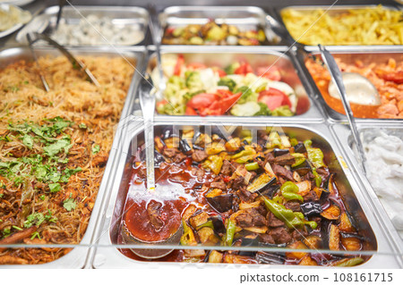 Various hot dishes . Glass Showcase in a buffet or self-service restaurant. Various hot dishes . Glass Showcase in a buffet or self-service restaurant. 108161715