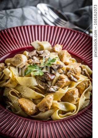 Tagliatelle pasta with forest mushrooms and chicken. Tagliatelle pasta with forest mushrooms and chicken. 108162073
