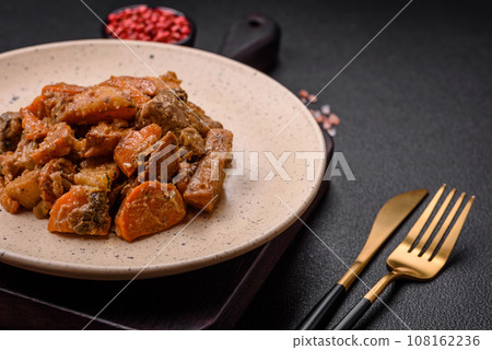 Delicious vegetable stew of potatoes, beef meat, mushrooms, carrots, salt, spices and herbs Delicious vegetable stew of potatoes, beef meat, mushrooms, carrots, salt, spices and herbs 108162236