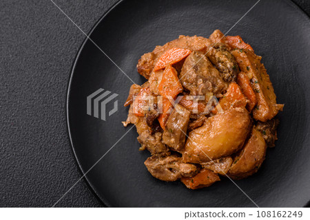 Delicious vegetable stew of potatoes, beef meat, mushrooms, carrots, salt, spices and herbs 108162249