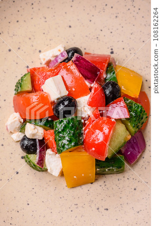 Delicious juicy Greek salad with feta cheese, olives, cucumber and tomatoes 108162264
