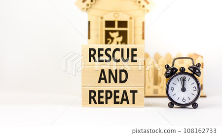 Rescue and repeat symbol. Concept words Rescue and repeat on wooden block on a beautiful white table white background. Black alarm clock. Business rescue and repeat concept. Copy space. 108162733