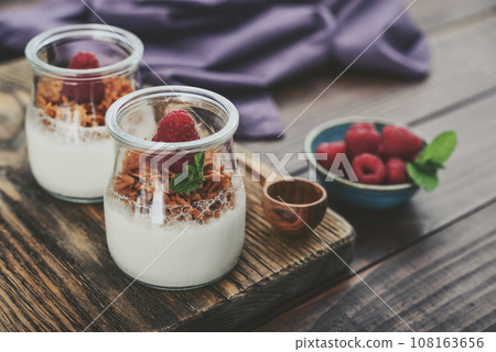 Dessert panna cotta with caramel cheese and fresh raspberry 108163656