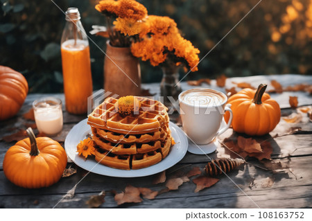 still life of a cup of hot latte and waffers and pumpkins on an old wooden table against the background of beautiful autumn nature at sunset, decoration for Halloween still life of a cup of hot latte and waffers and pumpkins on an old wooden table against the background of beautiful autumn nature at sunset, decoration for Halloween 108163752