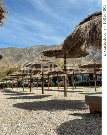 straw beach umbrellas in rows on the beach straw beach umbrellas in rows on the beach 108164002