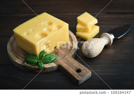 Cheese with holes large and small 108164147