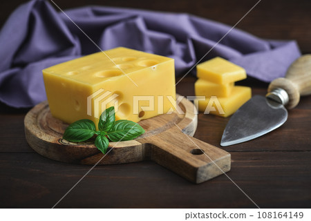 Cheese with holes large and small Cheese with holes large and small 108164149