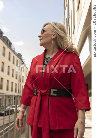 Portrait Beautiful Mature Sexagenarian Woman Standing in Street, Looking Away. Modern Building on Background. Stylish Senior Female in her 60s Wears Sunglasses. Businesswoman. Vertical Plane Portrait Beautiful Mature Sexagenarian Woman Standing in Street, Looking Away. Modern Building on Background. Stylish Senior Female in her 60s Wears Sunglasses. Businesswoman. Vertical Plane 108166365