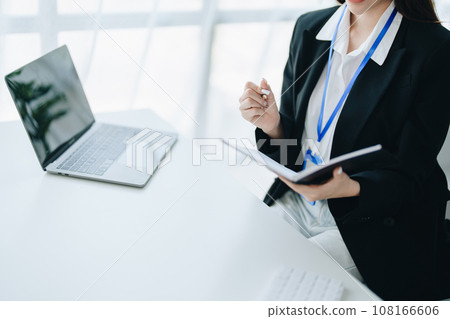 Consultant, advisor, Asian business woman working on the tablet computer work financial and marketing business plan to increase company profits, ready to use computer and marketing planning documents. 108166606