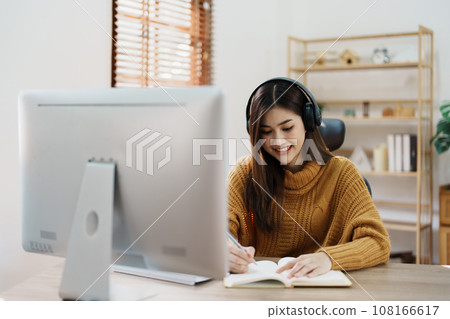 Studying online, beautiful Asian female student or student studying online at home. Studying online, beautiful Asian female student or student studying online at home. 108166617