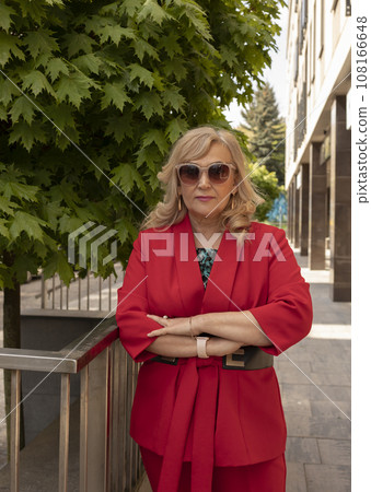 Portrait Posing Business Lady, Mature Sexagenarian Woman Outdoor in Summer Time, City, Stylish Confident Senior Female in her 60s Wears Sunglasses. Boss or Manager. Vertical Plane Portrait Posing Business Lady, Mature Sexagenarian Woman Outdoor in Summer Time, City, Stylish Confident Senior Female in her 60s Wears Sunglasses. Boss or Manager. Vertical Plane 108166648