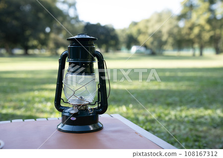 Table and lantern set at the campsite Table and lantern set at the campsite 108167312