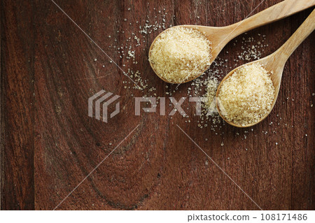 Top view two spoons of brown sweet  sugar  on wooden table with copy space. 108171486