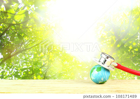 World Forestry, environment and global healthcare day - Earth with stethoscope against nature background. ESG 108171489