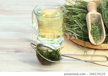 Herbal tea from Equisetum arvense, the field horsetail or common horsetail, dried herb in the basket. Herbal tea from Equisetum arvense, the field horsetail or common horsetail, dried herb in the basket. 108174135