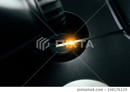 Car engine oil dipstick with reflective light on engine oil cap in a car engine compartment Car engine oil dipstick with reflective light on engine oil cap in a car engine compartment 108176129