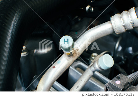 High pressure gas or liquid fill hole of car air conditioner system in a car engine compartment High pressure gas or liquid fill hole of car air conditioner system in a car engine compartment 108176132