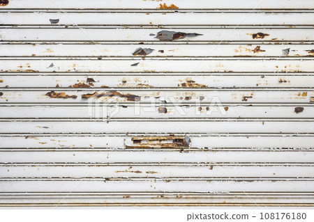 An image taken from the front of a rusty white shutter An image taken from the front of a rusty white shutter 108176180