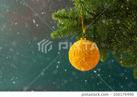 Christmas ball hanging on a fir branch Christmas ball hanging on a fir branch 108176490